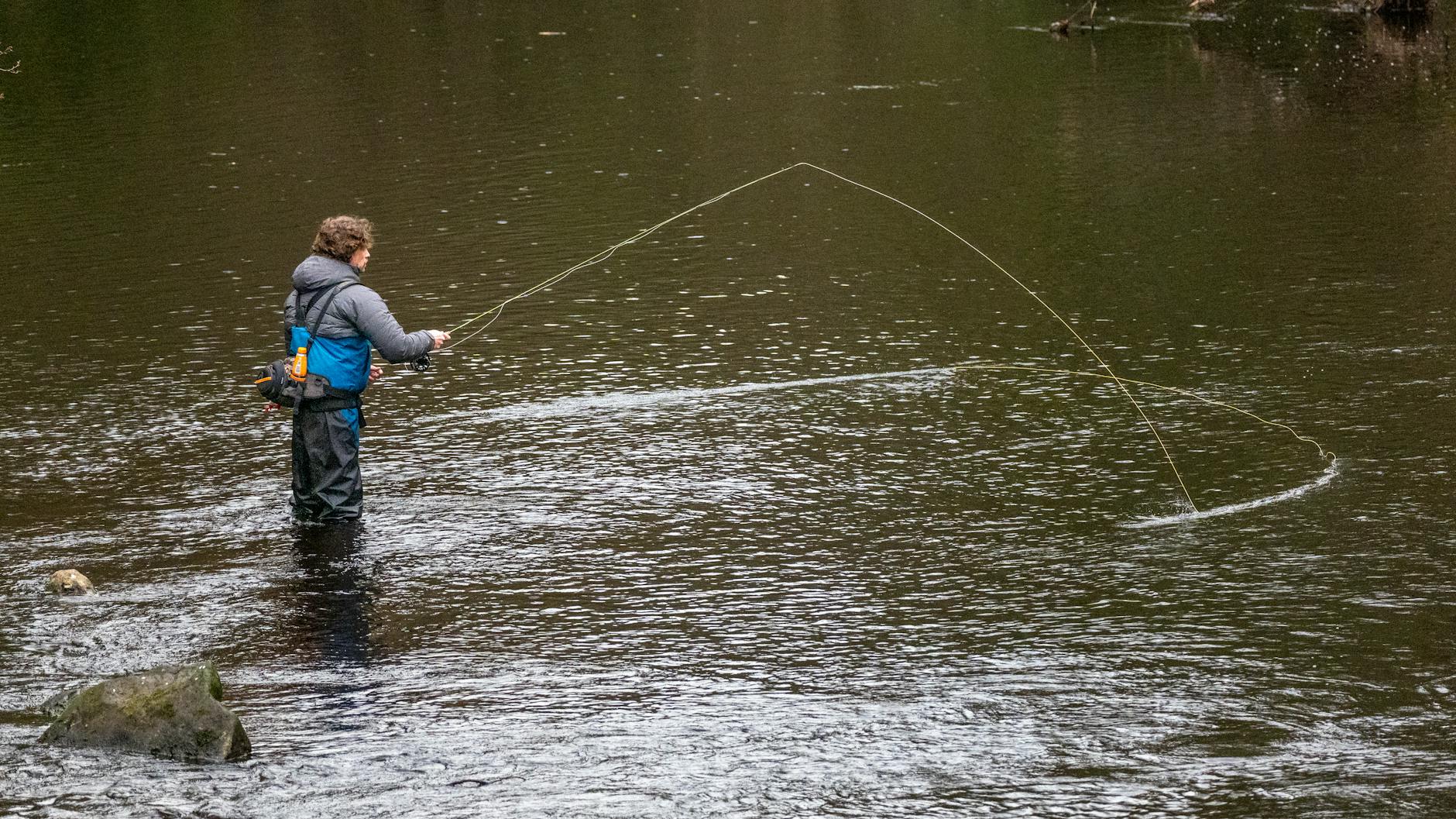 Fly fishing rod casting on calm water — Key West fishing fly fishing guide