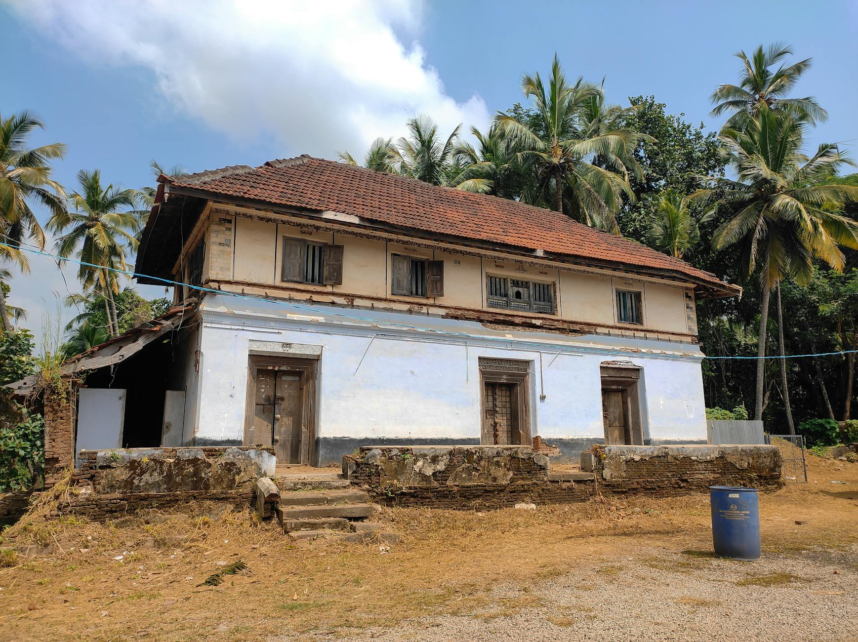 A beautifully preserved colonial-era home surrounded by tropical palms in Key West