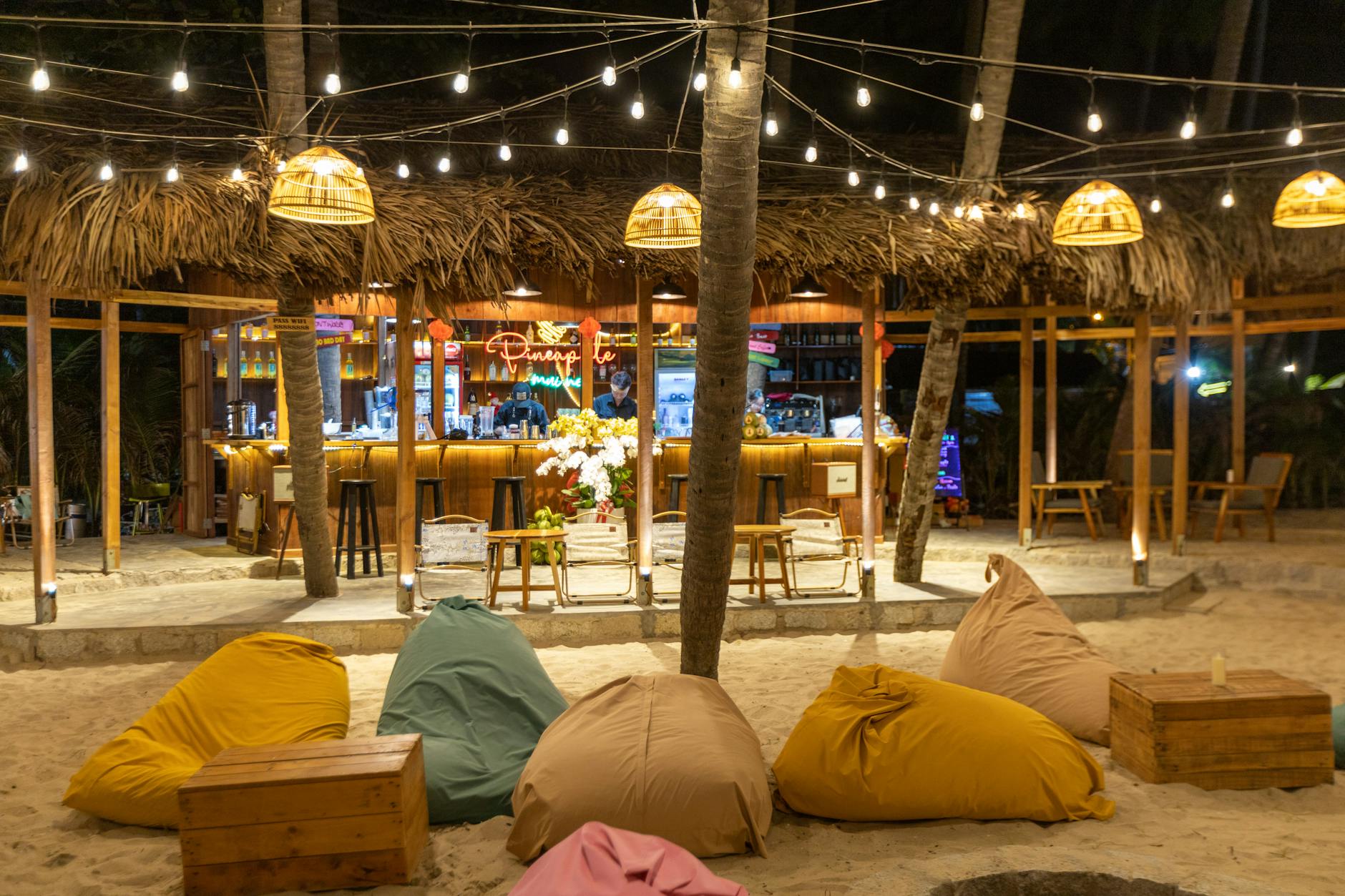 Open-air tropical bar setting under palm trees on a Key West evening