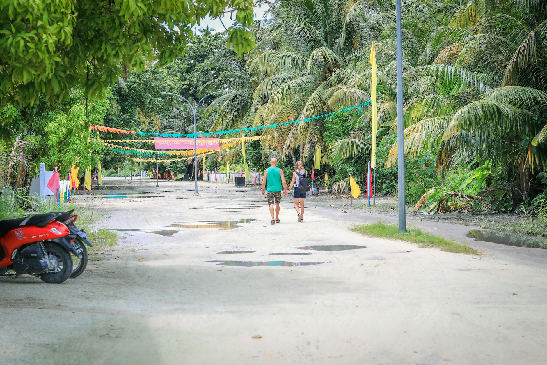 Couple exploring a tropical street on vacation — Key West vacation planning for couples