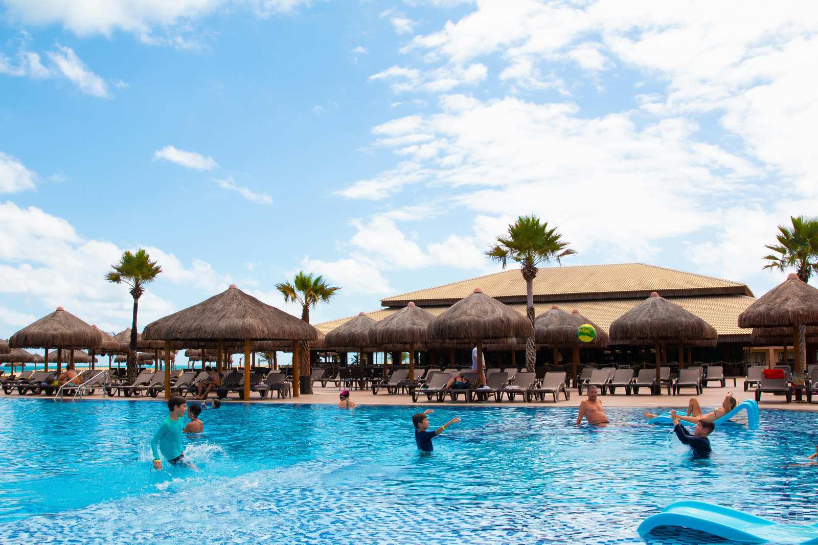 Family resort pool in Key West with palm trees and tropical landscaping