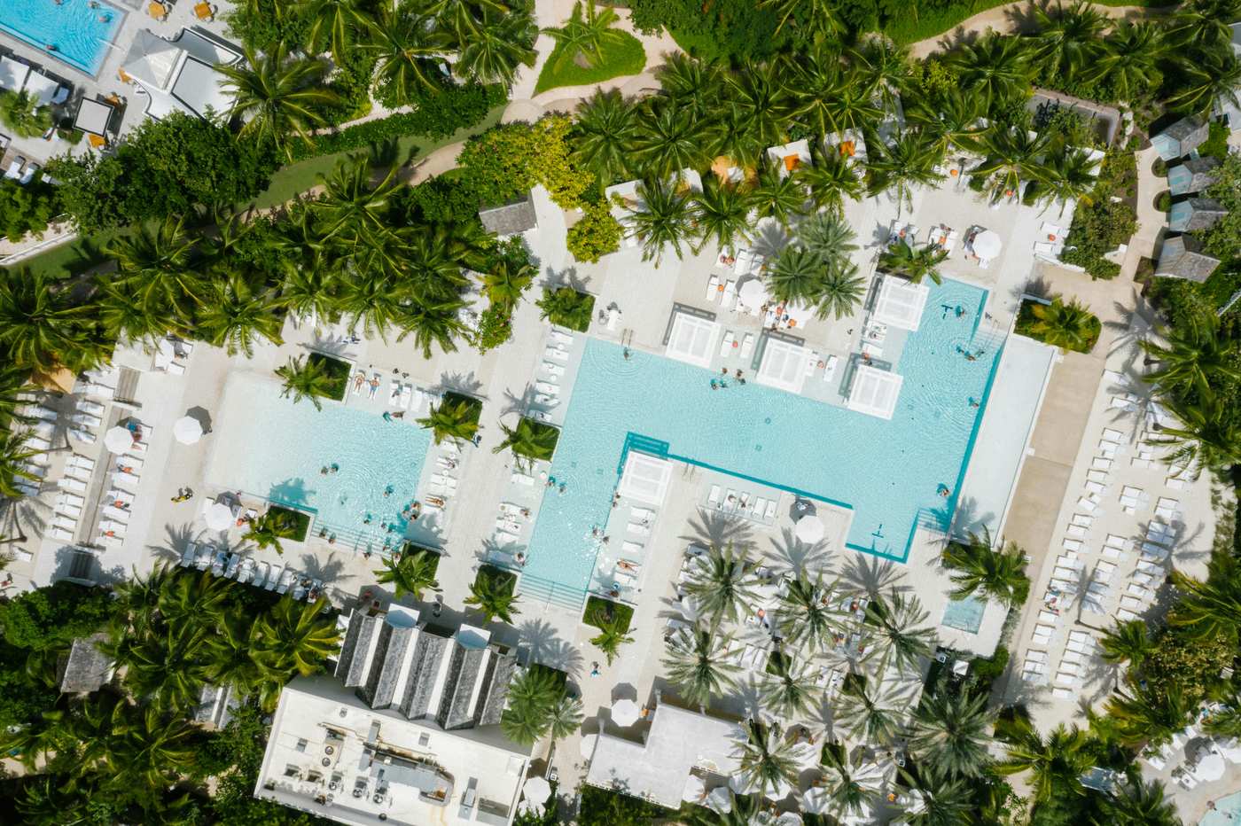 Key West luxury resorts aerial view with multiple pools and palm trees
