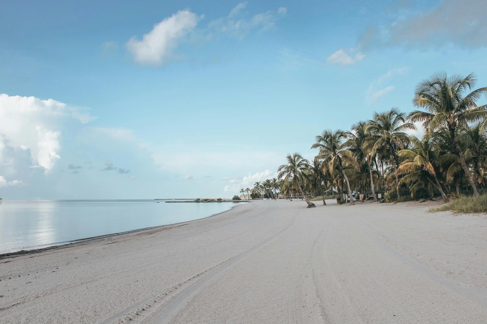 White sandy Smathers Beach in Key West with palm trees and turquoise water