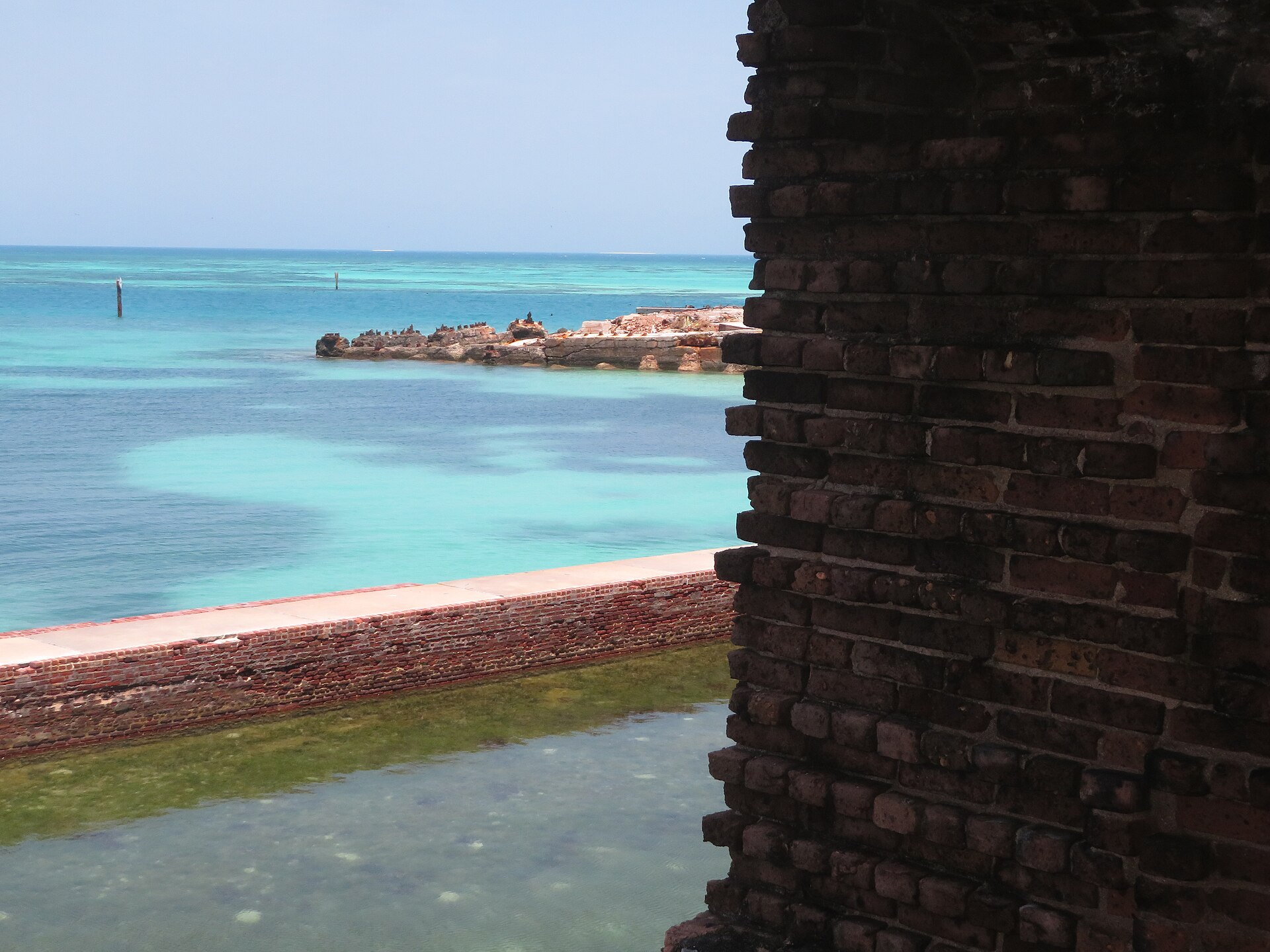 The brick wall of Fort Jefferson framing turquoise water and the moat wall at Dry Tortugas National Park