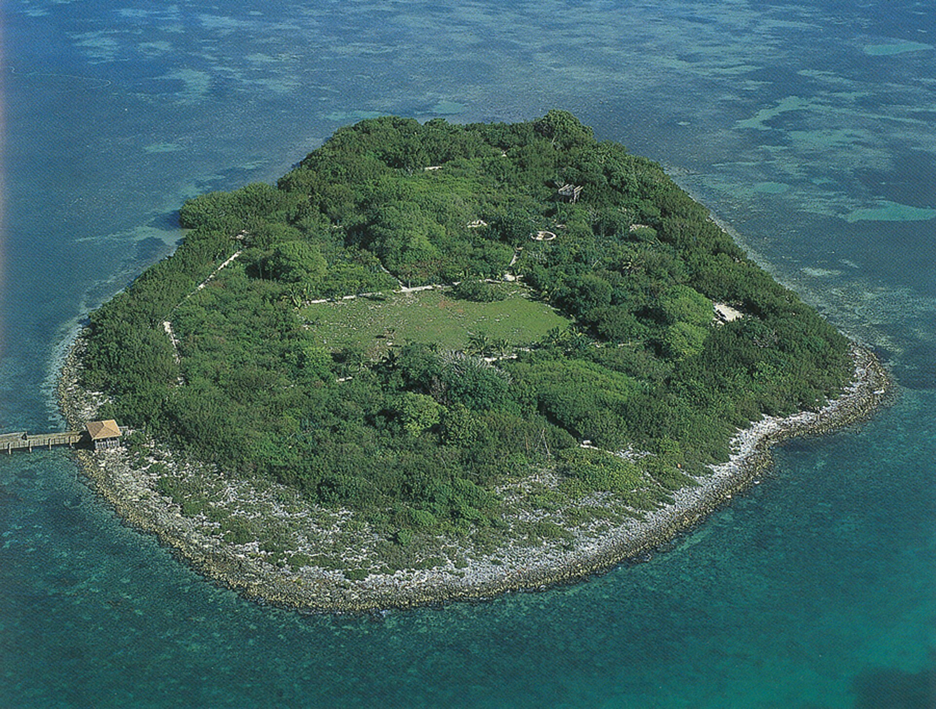 Aerial view of Indian Key, a small wooded island in the Florida Keys with a dock and a cleared central townsite