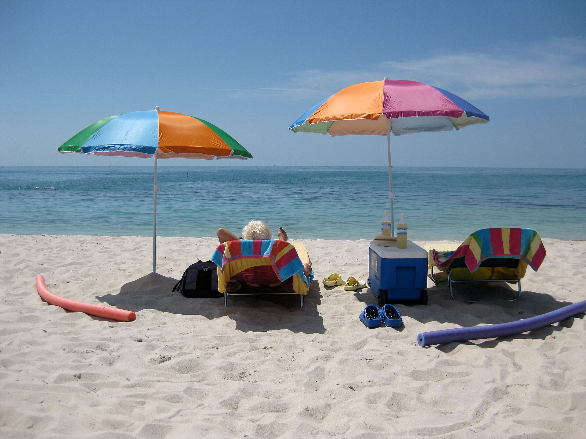 Beach umbrellas and loungers on the white sand at Sombrero Beach in Marathon with calm turquoise water